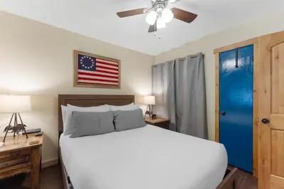 a bedroom with a bed and a flag on the wall at Snowdance 103 Building A in Keystone