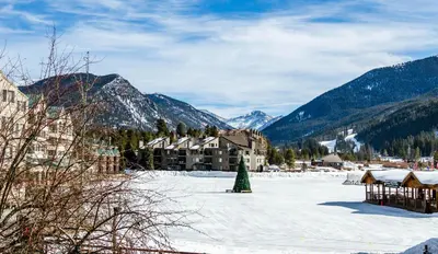 a resort with a christmas tree in the snow at Snowdance 103 Building A in Keystone