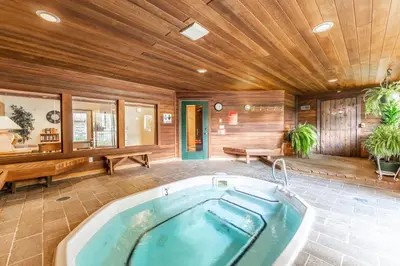 a bath tub in a room with a wooden ceiling at Snowdance 103 Building A in Keystone