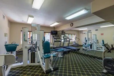 a gym with treadmills and machines in a room at Gateway 5036 in Keystone