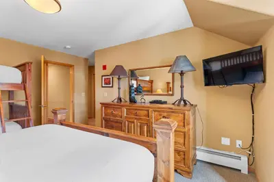 a bedroom with a bed and a flat screen tv at Gateway 5036 in Keystone
