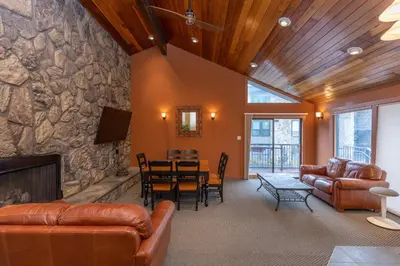 a living room with leather furniture and a stone wall at Lake Cliffe 307 Building A in Dillon