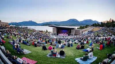 a large crowd of people sitting on the grass in front of a concert at Lake Cliffe 307 Building A in Dillon