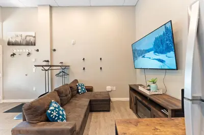 a living room with a couch and a flat screen tv at Lakeshore 4 in Keystone