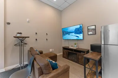 a living room with a couch and a refrigerator at Lakeshore 4 in Keystone