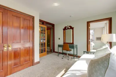 a bedroom with a bed and a desk and a mirror at Victorian-Style Cheesman Park Apt - 2 Mi to Dtwn in Denver