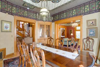 a dining room with a large wooden table and chairs at Victorian-Style Cheesman Park Apt - 2 Mi to Dtwn in Denver