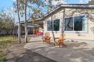 two chairs and a table in front of a house at Family-friendly | Ping-Pong | Game Rm | Fast Wifi in Arvada