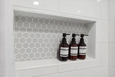 three bottles of wine sitting on a shelf in a bathroom at Family-friendly | Ping-Pong | Game Rm | Fast Wifi in Arvada
