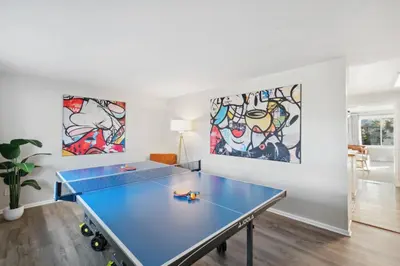 a blue ping pong table in a room with paintings at Family-friendly | Ping-Pong | Game Rm | Fast Wifi in Arvada