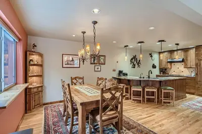 a kitchen and dining room with a wooden table and chairs at Gold Dust 660A in Frisco