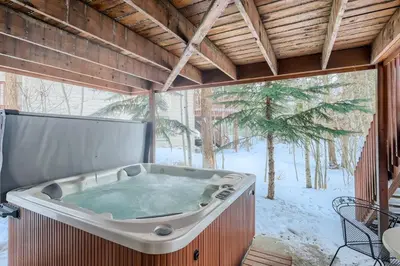 a jacuzzi tub in a room with snow on the ground at Gold Dust 660A in Frisco