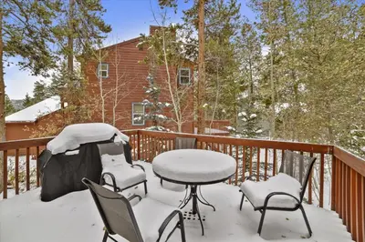 a balcony with a table and chairs covered in snow at Gold Dust 660A in Frisco