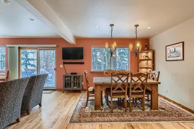 a dining room with a wooden table and chairs at Gold Dust 660A in Frisco