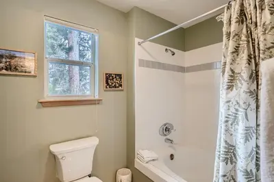 a bathroom with a toilet and a tub and a window at Gold Dust 660A in Frisco