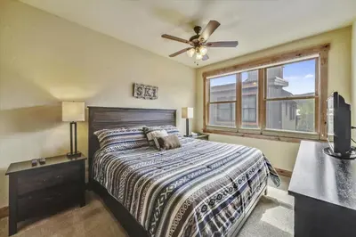 a bedroom with a bed and a ceiling fan at Apartments Off Main #4 in Frisco