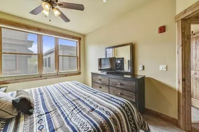 a bedroom with a bed and a mirror and a tv at Apartments Off Main #4 in Frisco