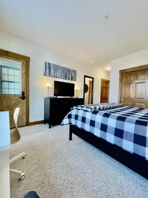 a bedroom with a black and white bed and a desk at 2 BR Basecamp Bliss at Kicking Horse Near Ski Hill in Granby