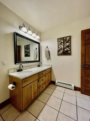 a bathroom with a sink and a mirror at 2 BR Basecamp Bliss at Kicking Horse Near Ski Hill in Granby