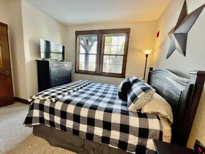 a bedroom with a black and white checkered bed at 2 BR Basecamp Bliss at Kicking Horse Near Ski Hill in Granby