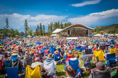 a large crowd of people sitting in chairs at a concert at Zephyr Escape in Fraser