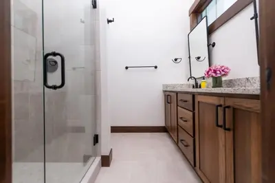 a bathroom with a shower and a sink and a mirror at Zephyr Escape in Fraser