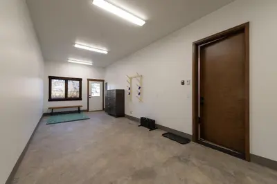 an empty room with a door and a bench at Zephyr Escape in Fraser