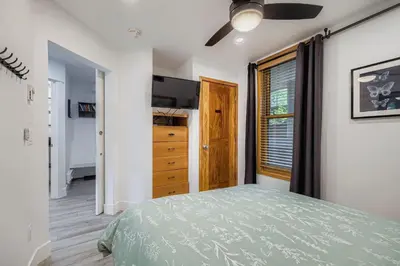 a bedroom with a bed and a dresser and a window at 2903 Riverbank Lodge condo in Keystone