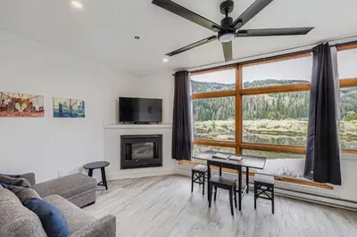 a living room with a couch and a fireplace at 2903 Riverbank Lodge condo in Keystone