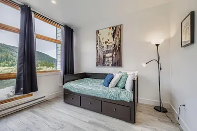 a bedroom with a bed and a window at 2903 Riverbank Lodge condo in Keystone