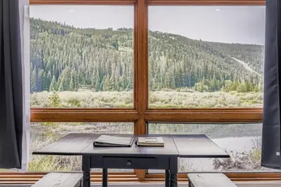 a table in a room with a large window at 2903 Riverbank Lodge condo in Keystone