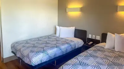a room with two beds in a hotel room at Motel West in Thornton