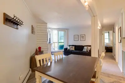 a dining room and living room with a table and chairs at Close to Rocky Mtn Slopes! Cozy Silverthorne Condo in Silverthorne