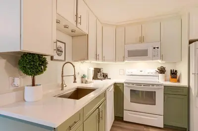 a kitchen with white cabinets and a sink at Close to Rocky Mtn Slopes! Cozy Silverthorne Condo in Silverthorne