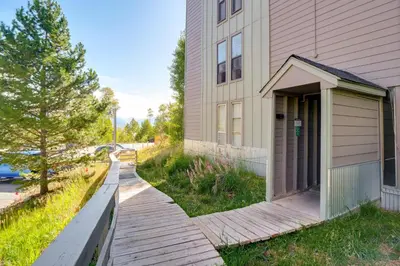 a house with a wooden walkway next to a building at Close to Rocky Mtn Slopes! Cozy Silverthorne Condo in Silverthorne