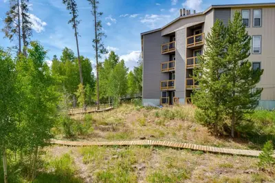 a building with a yard in front of a building at Close to Rocky Mtn Slopes! Cozy Silverthorne Condo in Silverthorne