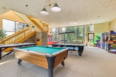 a room with two pool tables and a staircase at Close to Rocky Mtn Slopes! Cozy Silverthorne Condo in Silverthorne