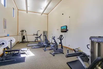 a gym with several treadmills and cardio equipment at Close to Rocky Mtn Slopes! Cozy Silverthorne Condo in Silverthorne