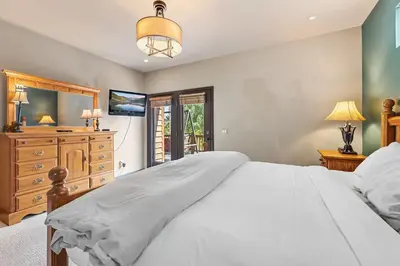 a bedroom with a large white bed and a dresser at Dog Friendly Stay Near Trails in Silverthorne in Silverthorne