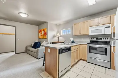 a kitchen with a stove top oven next to a couch at Dog Friendly Stay Near Trails in Silverthorne in Silverthorne