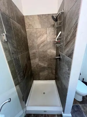 a bathroom with a shower with a toilet at Miners Cabin at Base Camp Lodging Company in Dumont