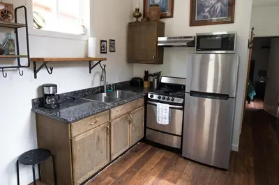 a kitchen with a stainless steel refrigerator and a sink at Miners Cabin at Base Camp Lodging Company in Dumont