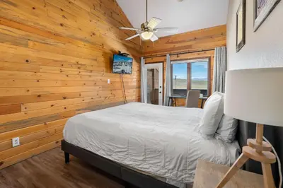 a bedroom with a bed and a ceiling fan at Rocky Mountain Retreat in Granby