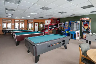 a room with several pool tables and arcade machines at Rocky Mountain Retreat in Granby