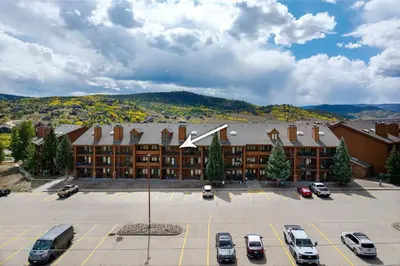 a large building with cars parked in a parking lot at Rocky Mountain Retreat in Granby