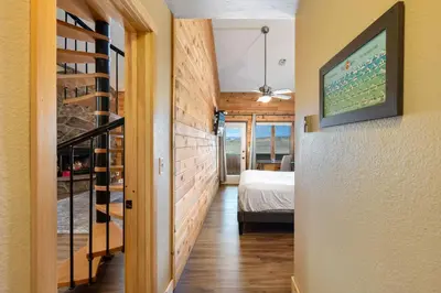 a hallway with a bedroom and a bed in a room at Rocky Mountain Retreat in Granby