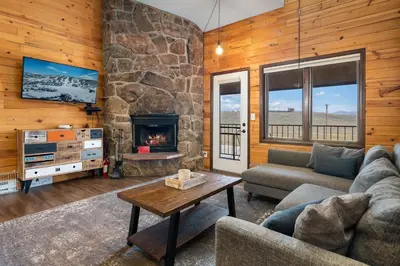 a living room with a couch and a fireplace at Rocky Mountain Retreat in Granby