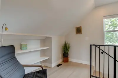 a living room with white walls and a stair case at Walk to Med Ctrs and Dtwn Englewood Modern Home in Englewood