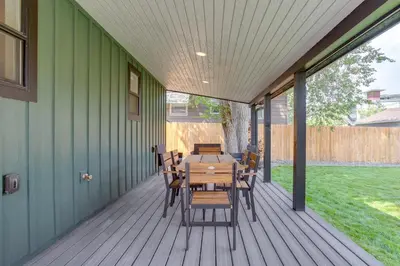 a wooden deck with a table and chairs on it at Walk to Med Ctrs and Dtwn Englewood Modern Home in Englewood