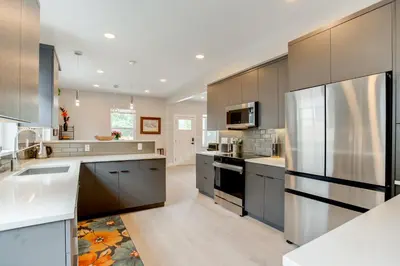 a large kitchen with stainless steel appliances at Walk to Med Ctrs and Dtwn Englewood Modern Home in Englewood